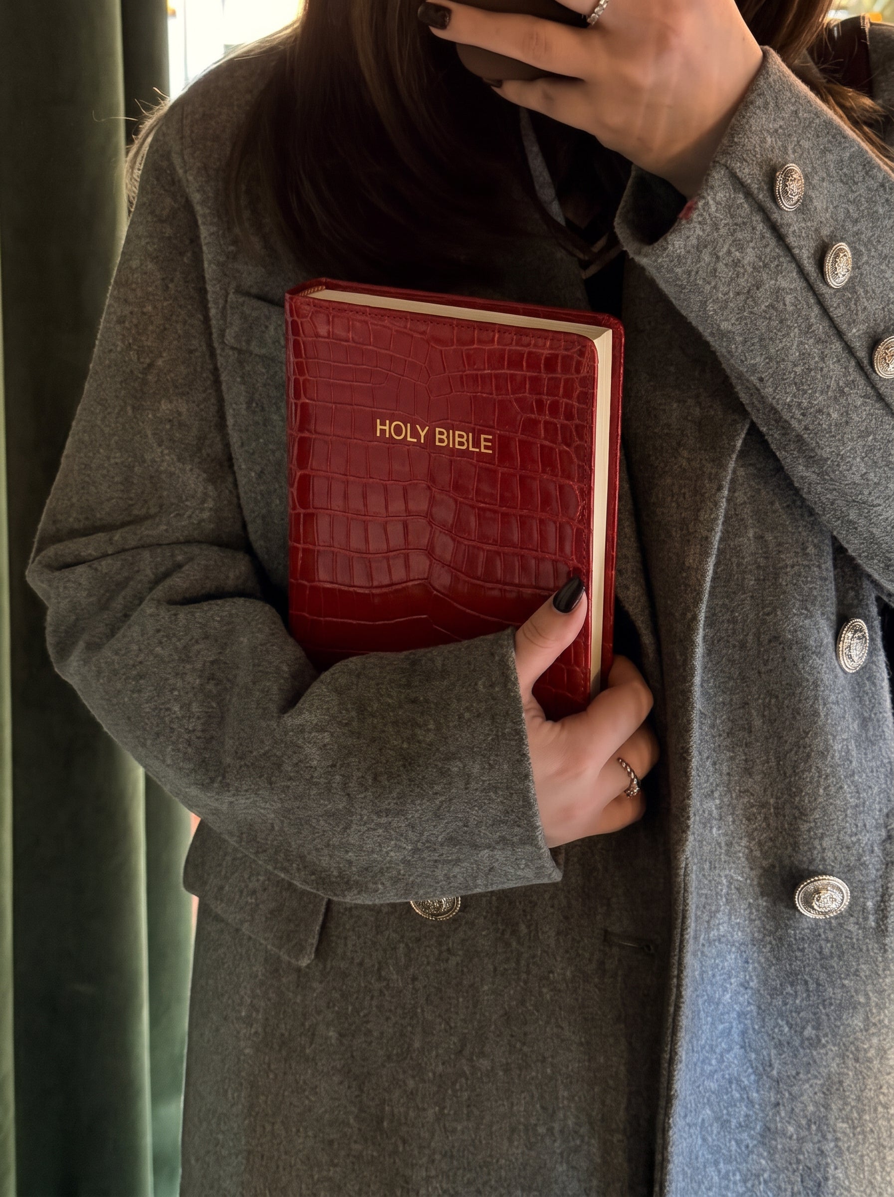 Red Everyday Bible Cover carried under a wool coat