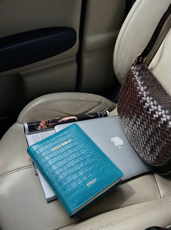 Teal Everyday Bible Cover on a car seat with a bag